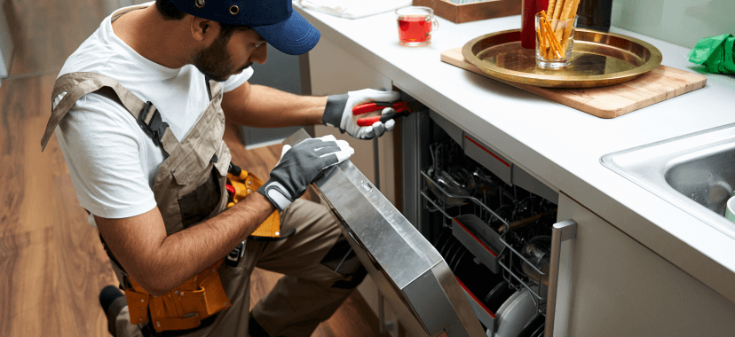 Technician repairs appliance